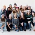 A group of 16 girls wearing Love Your Melon hats pose for a picture at a Love Your Melon Photoshoot. Emma was a superhero recipient for Love Your Melon. LYM is an organization dedicated to putting a hat on every child battling cancer. However, and thankfully Emma does not have cancer. The organization recognized her battle with Mast Cell Disease.